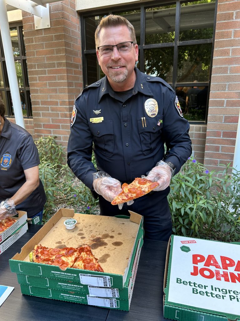 Commander Dunn serving pizza at the Chandler Police Department Pizza With Police 2025 event