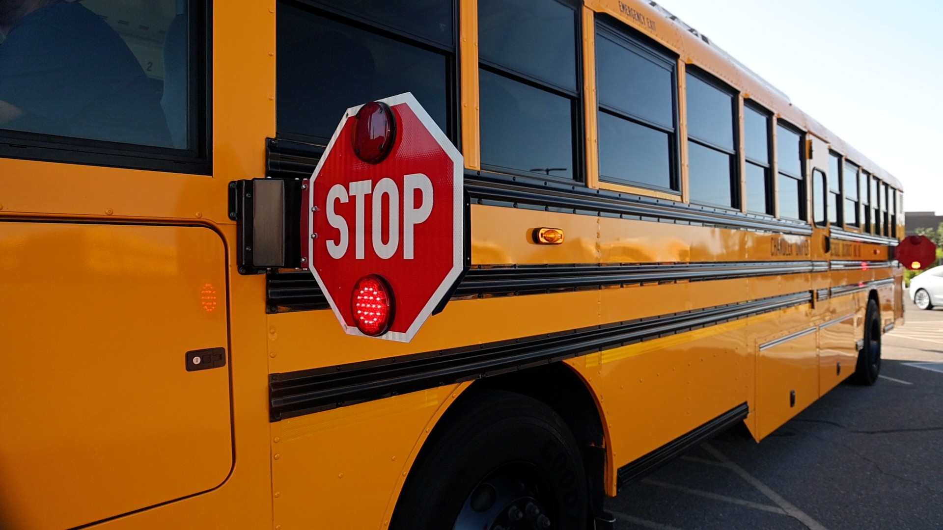 Chandler Unified School district School bus showing a stop sign in order to help promote the image of safety around school zones